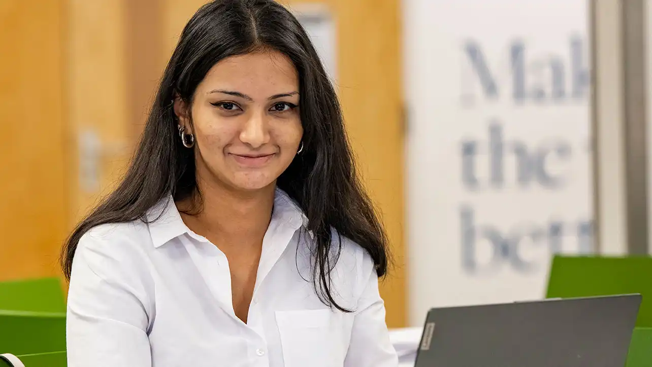 Female University of Southampton student sitting in front of a laptop