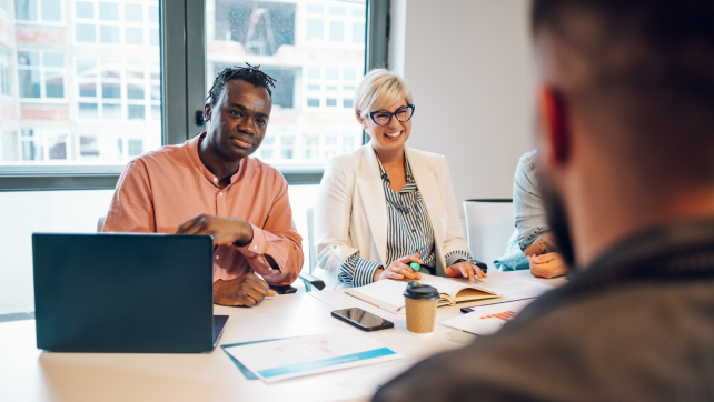 Two people smiling in a meeting