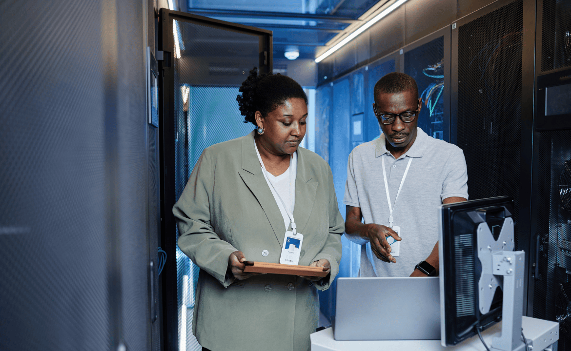 Two people working in a data centre