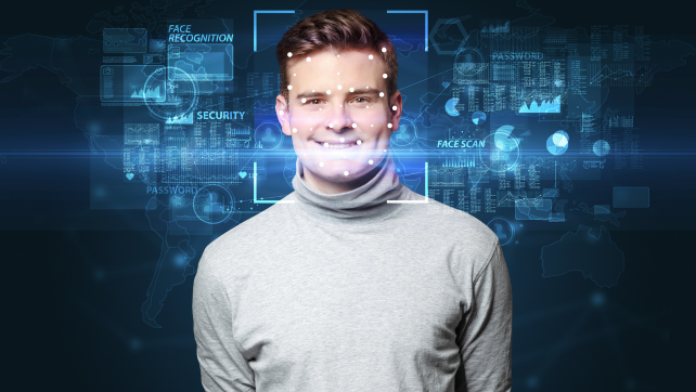 Smiling AI professional, standing in front of the camera and smiling