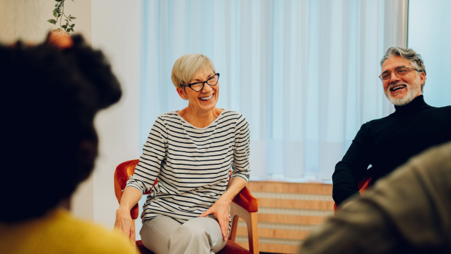 Adults participating in a group therapy session, highlighting mental health support.
